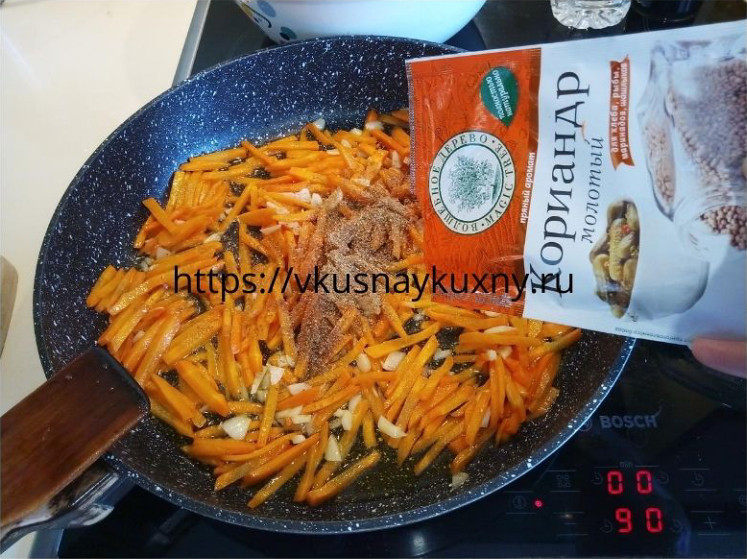 Посыпаем молотым кориандром морковь для корейского салата с чесноком